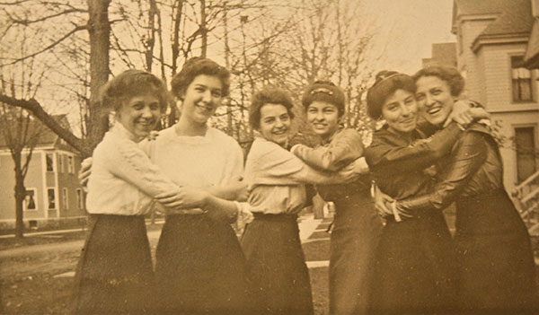 A historical photo of women in a group hug